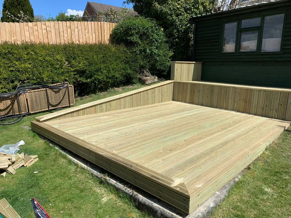 Raised timber decking platform with built-in seating