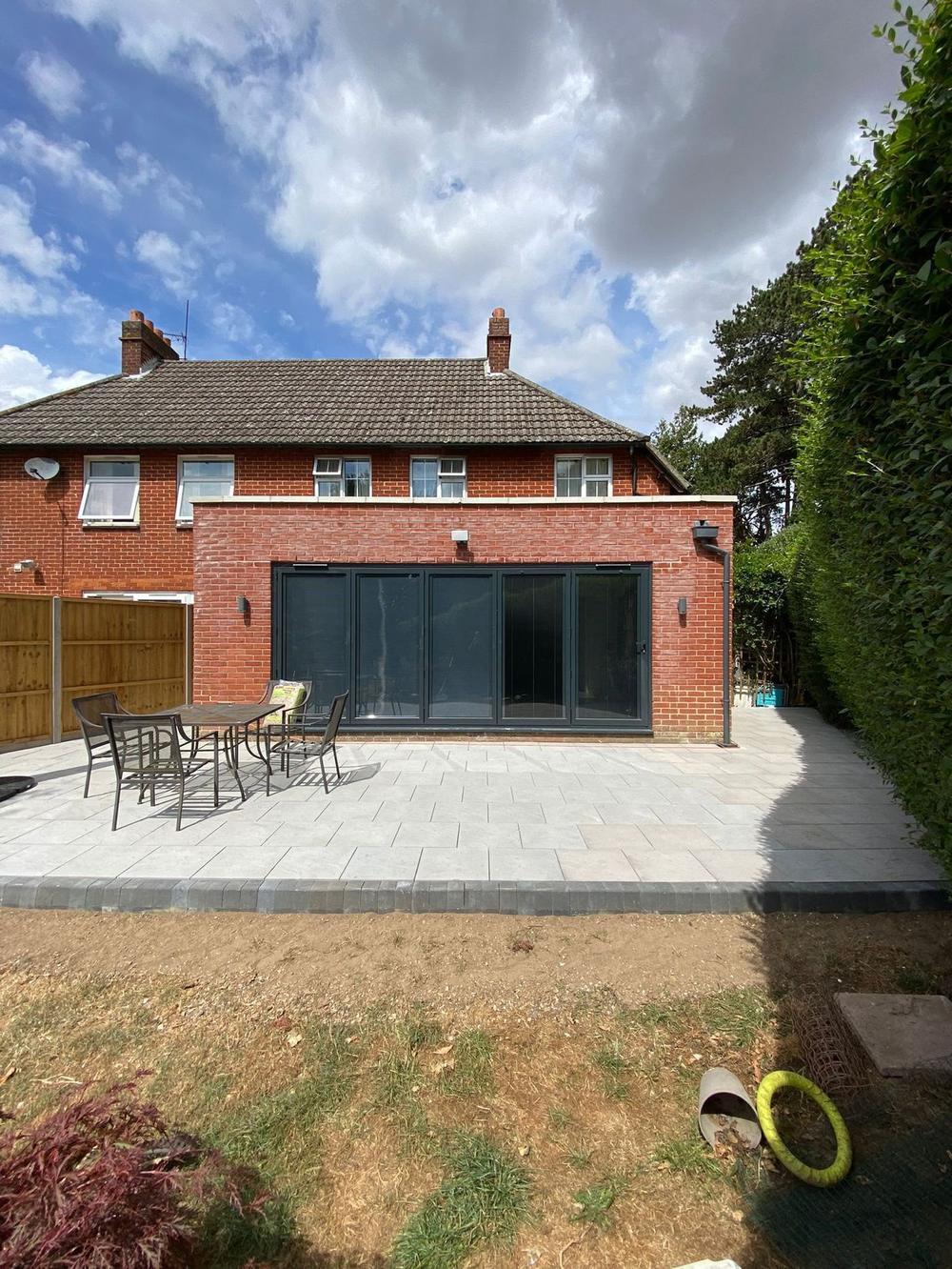 Brick rear extension with bifold doors and patio