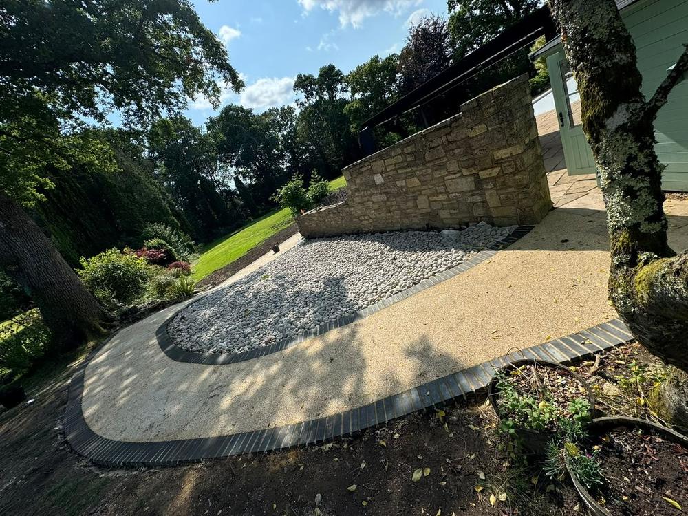 Curved resin-bound driveway with stone edging